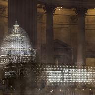 The Capitol in Washington is illuminated during a thunderstorm with the rotunda of the Russell Senate Office Building reflected on the rain-covered windows, late Wednesday afternoon, Feb. 24, 2016.