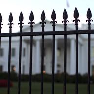 In this Sept. 23, 2014, file photo, the White House is seen through the North Lawn perimeter fence in Washington.