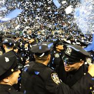 The June 2014 class of NYPD cadets holding a graduation ceremony at Madison Square Garden. The 610 graduates are 51% minority, 20% women, and come from 47 countries.