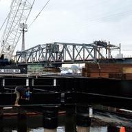 Workers have begun building a pier that will help with the construction of the Portal North Bridge. The projects is in limbo until the federal government commits to funding half of the $30 billion.