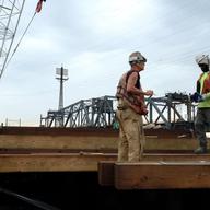 Workers have begun building a pier that will help with the construction of the Portal North Bridge. The projects is in limbo until the federal government commits to funding half of the $30 billion.