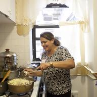 Nawida Saidhosin teaching an Afghani cooking workshop in her kitchen.