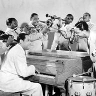 Duke Ellington (seated) and members of his famous Ellington Orchestra.