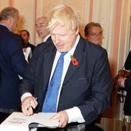 : Mayor of London Boris Johnson signs copies of his new book 'The Churchill Factor: How One Man Made History' at Dartmouth House on October 22, 2014 in London, England.