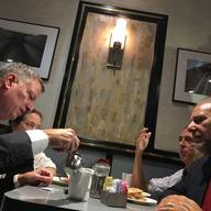 Mayor Bill de Blasio and Commissioner Joseph J. Esposito sits down with customers Steve Rosenthal and Jennifer Gilson at the Malibu Diner on 23rd Street in Chelsea three days after a bomb explosion.