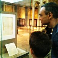 Visitors read the copy of the Declaration of Independence handwritten by Thomas Jefferson 