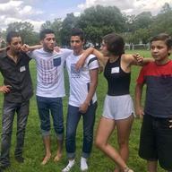 Syrian and American teens gather together on a field in summer 2017.