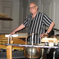 Composer George Crumb amidst instruments