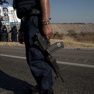 Soldiers and Federal Police officers install a checkpoint on a road inside the zone of influence of La Familia drug cartel on December 12, 2010 in Apatzingan, Mexico. 