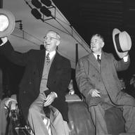 American incumbent President Harry S. Truman (1884 - 1972) (left) and Vice President-elect Alben Barkley (1877 - 1956) wave as they return to Washington after their victory in the 1948 presidential el