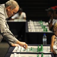 Former World Chess Champion Garry Kasparov plays a game of chess against eight-year old Ronan Ferreira on March 25, 2012in Pretoria, South Africa. 
