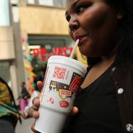 Lori Middleton drinks a large soda on October 17, 2013. A lower court ruling blocked Mayor Michael Bloomberg's campaign to stop fast food restaurants from selling super-sized, sugary drinks.