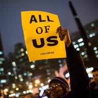  A woman attends a rally calling on greater social equality, organized by non-unionized fast food workers demanding for a wage raise from $7.25 per hour to $15.00 per hour.