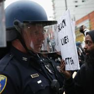 A protesters shows a sign to the police during a march in honor of Freddie Gray on April 25, 2015 in Baltimore, Maryland.
