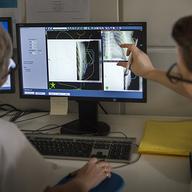 Radiotherapy, Radiation oncology service, Radiotherapy session with the latest linear accelerator, the True beam. Two nurses control a treatment session for breast cancer.