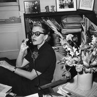 Fleur Fenton Cowles, writer and Associate Editor of Look magazine, sits and talks on the phone behind her office desk in 1955.