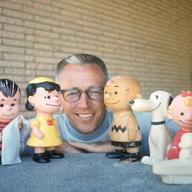 Charles M. Schulz with a few of his Peanuts characters, including (from left) Linus (with blanket) Lucy van Pelt, Charlie Brown, and Snoopy. Image dated January 1, 1962.