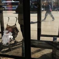 A child and mother wait for a bus in Camden, NJ. Poverty