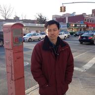 Hsi-Pei Liao at an intersection in Flushing. Behind him is the street where his four-year-old daughter, Allison, was struck and killed by an SUV.