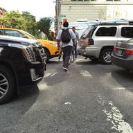 Pedestrians try to squeeze through traffic along Varick Street in Manhattan. 