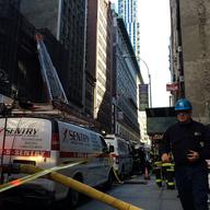 Rescue crews at the site of a fatal construction accident in Midtown in which an internal collapse killed one and seriously injured another worker.