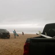 Trucks full of surfers and surfboards pull up on the town beach at Montauk on the Friday before Memorial Day. The surf was pounding and despite the fog and light drizzle, the beach coastcheck