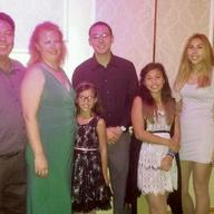 Cloyd Edralin, left, shown in this family photo with his wife and four children, is now in immigration detention. 