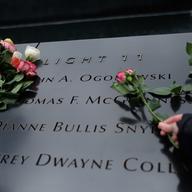 Visitors leave flowers on the names of the six victims of the 1993 World Trade Center bombing on the 25th anniversary of the attacks.