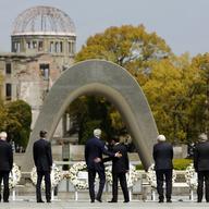 US Secretary of State John Kerry (center L) puts his arm around Japan's Foreign Minister Fumio Kishida (center R) at the memorial site in Hiroshima. 