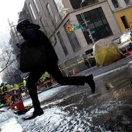 A water main break early on January 15, 2013 leaves a crater in the street at 13th Street and 5th Avenue.
