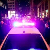 NYPD car trying to drive through protests in Midtown following the decision not to indict an officer in the death of Eric Garner.