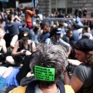 Protestors stage a sit-in on Broadway near Wall Street called Flood Wall Street, hoping to draw awareness to the connection between corporations and climate change.