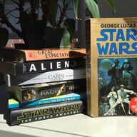 Copies of the novelizations of Star Wars, Great Expectations, Alien, The Cabin in the Woods, Pacific Rim, The Cat in the Hat, and Star Wars: The Force Awakens.