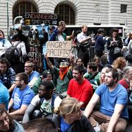 Protestors stage a sit-in on Broadway near Wall Street called Flood Wall Street, hoping to draw awareness to the connection between corporations and climate change.