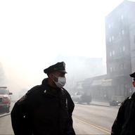 NYPD and hundreds of firefighters responded to a 5-alarm fire at the site of two building explosions in East Harlem on March 12, 2014.