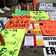 Poster and a vigil for Eric Garner at the site where he was killed.