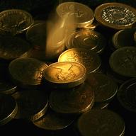 Pound coins drop into a pile on November 27, 2008 in Bristol, England.