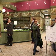 Protesters inside the Grand Cafe, claiming the owner unfairly fired 4 workers for union organizing.