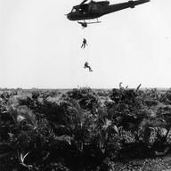 U.S. Navy SEALS repel down ropes from a U.S. Army Bell UH-1B Iroquois helicopter to set an ambush in the jungle below during operations in South Vietnam.