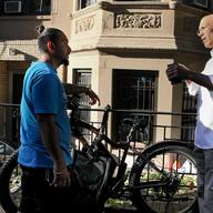 Matthew Shefler and biker Jonathan Lyons discussing the legality of electric bikes. Lyons insists he's a careful rider, but Shefler points out this type of electric bike, with a throttle, is illegal.