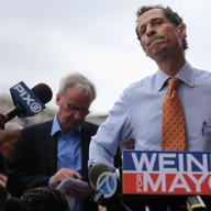 Anthony Weiner listens to a question from the media after courting voters outside a Harlem subway station a day after announcing he will enter the New York mayoral race.  May 23, 2013