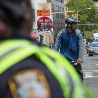 A cyclist attempts to cross Houston Street at 2nd Avenue in Manhattan.
