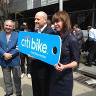 NYC Deputy Mayor Howard Wolfson (left) and NYC Transportation commissioner Janette Sadik-Khan hold an oversized replica of a bike share key-card. 