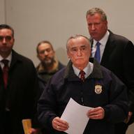  New York City Police Commissioner William J. Bratton is followed by Mayor Bill de Blasio at a news conference atWoodhull Hospital following the killing of two New York City police officers.