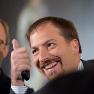 NBC News' Chuck Todd gives a thumbs up before US President Barack Obama makes his way to the stage for a press conference November 14, 2012.