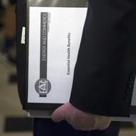 House Energy and Commerce Committee Chairman Rep. Greg Walden, R-Ore., one of the stewards of the Republican health care legislation, carries a binder labeled 'Essential Health Benefits.' 