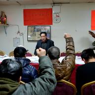De Quan Lu, the head of a Fujianese community association meeting with e-bike delivery workers to discuss the NYPD's crackdown.