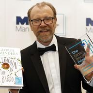 George Saunders with his book 'Lincoln in the Bardo' after being announced winner of the 2017 Man Booker Prize, in London, Tuesday, Oct. 17, 2017