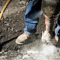 A construction worker uses a jackhammer in New York City.