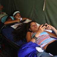 Female campers uses iPhone at summer camp
